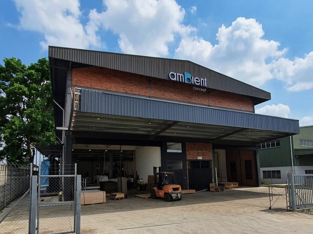 The Ambient Concept workshop and warehouse, a steel-framed building with brick gable and box-up signage, a forklift at the loading bay